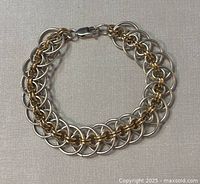 Front view of the 7-inch 925 silver and copper bracelet laid flat on surface showing design and clasp.