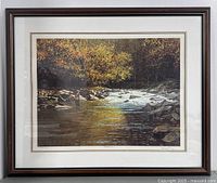 Frontal photo showing the full framed print with autumn river scene.