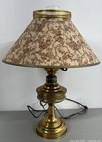 Full vintage brass lamp with floral fabric shade, unplugged