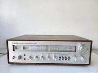 Front left angle view showing faceplate controls, tuner scale and meters