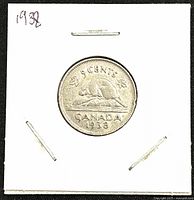 Front view of 1938 Canadian nickel 5 cents coin showing beaver on log and inscriptions.