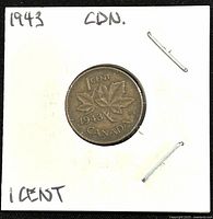 Reverse side of 1943 Canadian 1 cent coin showing maple leaf design and denomination with date.