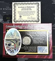 Photo of the certificate of authenticity and the 1946 silver 50 cents coin with packaging showing historical Canadian scenes.