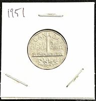 Reverse side of the 1951 Canadian Big Nickel 5 cents coin showing commemorative design with nickel mining lettering and maple leaves.