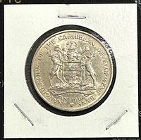 Obverse of 1970 Antigua 4 Dollar coin showing Antigua coat of arms and Caribbean Development Bank inauguration text.