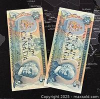 Two Canadian five dollar banknotes dated 1972 and 1979 laid side by side, showing front design and colors.