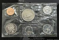 Photo showing the front side of 6 coins sealed in plastic with Canadian symbols and denominations visible.