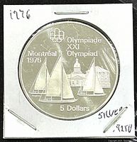 Reverse side of the coin displaying the 1976 Montreal Olympics sailboats design with denominations and Olympic inscriptions.