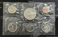 Six 1974 Canadian proof-like coins in original plastic packaging, front side showing various Canadian designs and Queen Elizabeth II on the reverse.