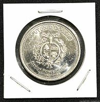 Obverse side of the 1982 Canadian Prince George trade dollar coin, showing shield and 'SOUVENIR DOLLAR' text.