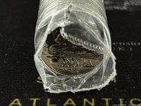 Close-up of the end of the roll showing the 2001 Canadian 5 cent coin face with clear 'CANADA' and '2001' visible.