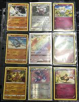 Top view of nine Pokémon cards in sleeves arranged in a 3x3 layout. Cards show various characters, including holographic and GX cards.