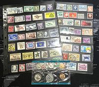 Two pages of assorted US stamps in plastic sleeves showing a variety of stamp designs and colors.