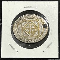 Front view of oval metal medallion charm with East Coast Airlines logo and text