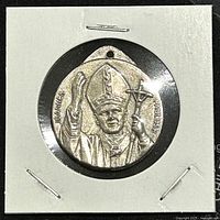 Obverse side of medal showing Pope John Paul II with papal mitre, staff, and inscriptions.
