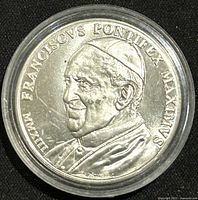 Front side of medal showing profile of Pope Francis with inscription FRANSCISCUS PONTIFEX MAXIMUS