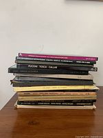 Stack of vintage vinyl records showing titles such as Puccini Tosca Callas, Offenbach La Vie Parisienne, and others, illustrating a collection of classical and operatic works in used outer sleeves.