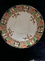 Full view of the 9-inch china plate showing the floral and textured border pattern with gold, green, and brown accents.