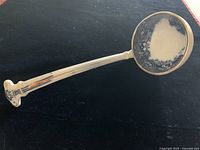 Full view of the antique gravy boat with detailed ornate handle, showing gold trim and blue floral pattern on bowl.
