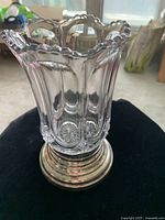 Front and side view of the glass celery vase showing scalloped edges and silver plated base.