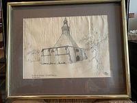 Framed pencil sketch artwork on paper showing The Abbot's Kitchen architectural scene with surrounding trees, displayed behind glass in a gold-tone metal frame.
