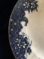Close up of floral and pattern design and gold rim edge of the James Kent Empress Flow Blue platter