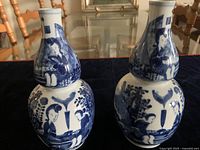 Two blue and white porcelain double-gourd vases with figurative and floral decorations