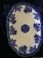 Full top view of the oval serving platter showing blue floral patterns on white ceramic base