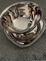 Silver-plated gravy boat with ribbed base and reflective finish shown upright.