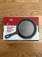 Box of Betty Crocker 6 inch pre-seasoned cast iron frypan showing front packaging with product image and details.