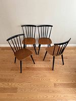 Four chairs arranged in semicircle, angled view