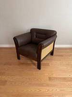 Chair at front-left angle on wood floor against white wall