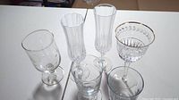 Top view of 6 assorted glassware pieces showing etched and plain patterns