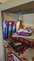 Shelf with assorted body lotions, gift bags, and stationery items