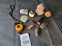 Overview of all items in the lot on black surface with auction tag visible