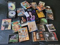 Photo showing a collection of various DVD and Blu-ray movie cases laid out on a surface including titles such as Kill Bill, Semi-Pro, Hot Fuzz, The Blair Witch Project, and others.