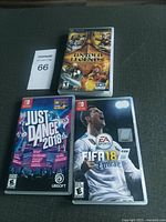 Image showing three game cases: Untold Legends PSP game, Just Dance 2018 and FIFA 18 Nintendo Switch games.