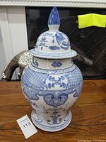 Front view of the ginger jar with lid showing the full body and decorative blue and white patterns.