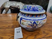 Front view of jar showing dragon and wave motifs and side ring handle