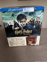 Front view of Harry Potter 31-disc Blu-ray and DVD set box with characters and branding visible.