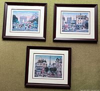 Three framed Parisian street scene art prints arranged on the floor, showing overall lot contents and framing details.