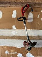 Side view of the Toro electric string trimmer showing the full length and details of the handle, shaft, and trimming head.