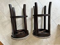 View of the stools upside down showing the wood frames and underside of the seats.