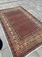 Full view of rug laid flat on stone pavement