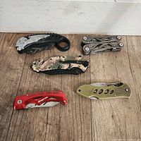Top view of 7 pocket cutters and multi-tool showing blade backs and handles