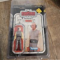 Front view of the sealed Kenner Star Wars Lobot action figure in original blister card packaging with case protector