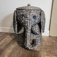 Front view of the elephant-shaped wicker basket showing detailed elephant face with ears, trunk, eyes and tusks.