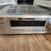 Front view of Onkyo TX-SR603X AV receiver powered on, showing "DVD - 29" on display with silver finish and multiple buttons and volume knob