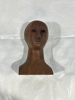 Front view of the dark wood carving bust sculpture showing facial details and smooth finish.