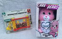 Photo showing Nature Explorers Interactive Habitat Kit Ant House and Care Bears Hopeful Heart Bear in packaging
